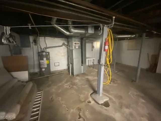 Unfinished below grade area with water heater and heating unit