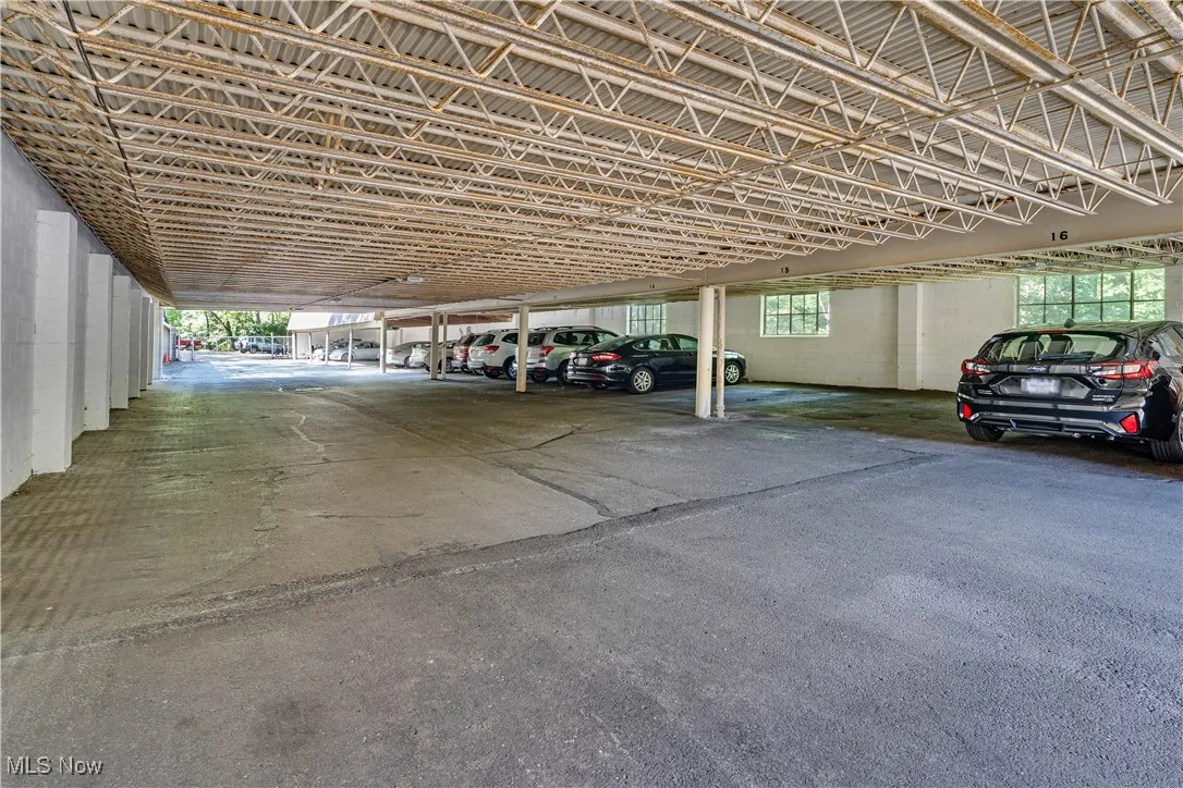 View of vehicle parking with a parking garage