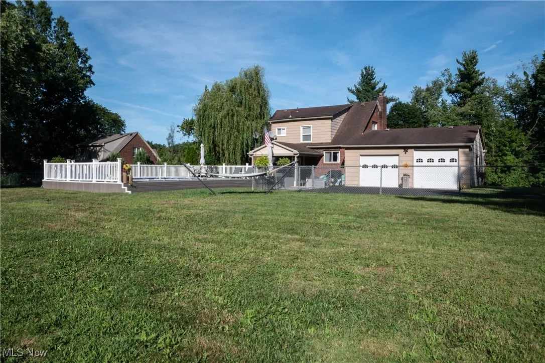 View of yard featuring a garage and a deck