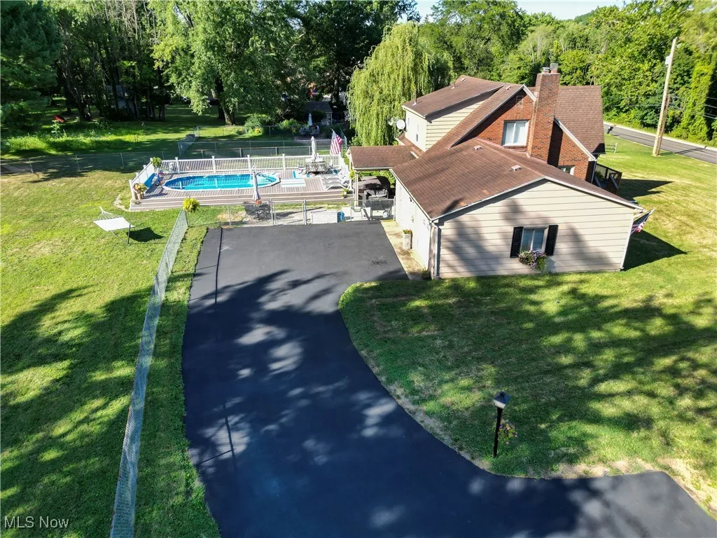 View of subject property with a pool