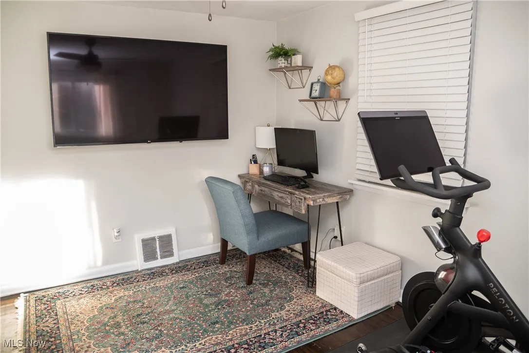Bedroom featuring wood finished floors and baseboards