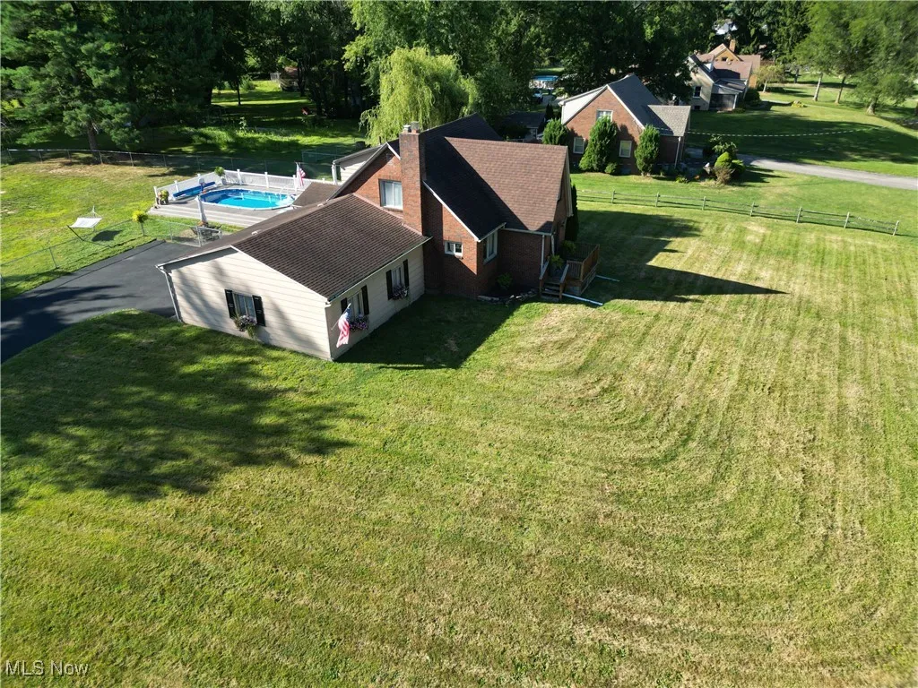 Aerial view of property featuring a pool