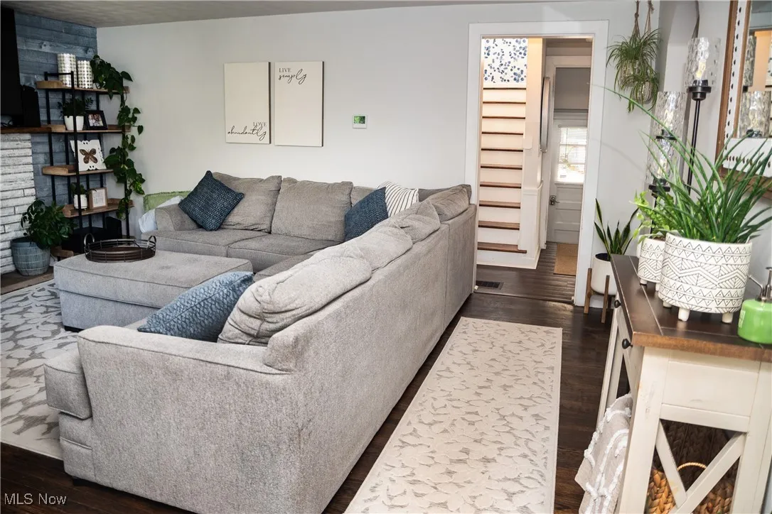 Living area featuring dark wood-style floors