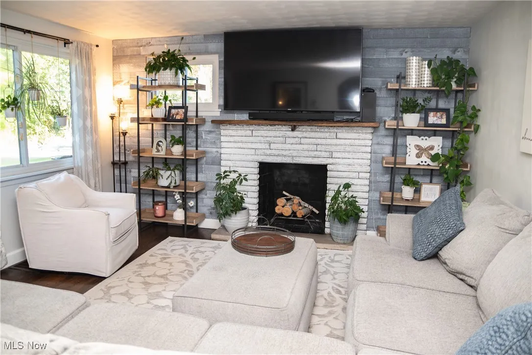 Living room featuring wood finished floors and a fireplace
