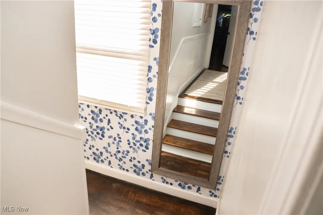 Stairway featuring wood finished floors and baseboards