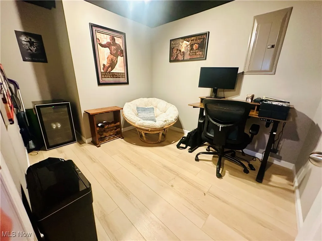 Office space with wood finished floors and electric panel