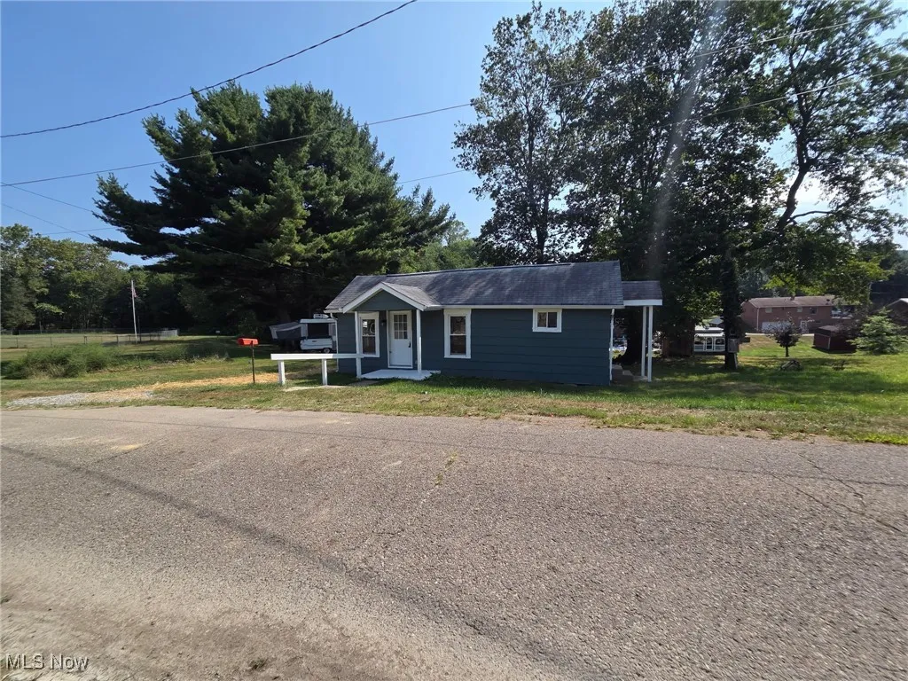 Bungalow-style house featuring a front lawn
