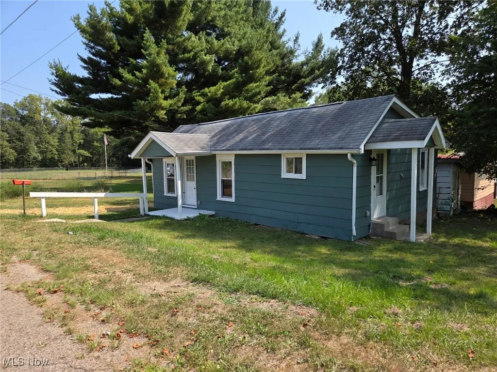 View of front of home featuring a shingled roof