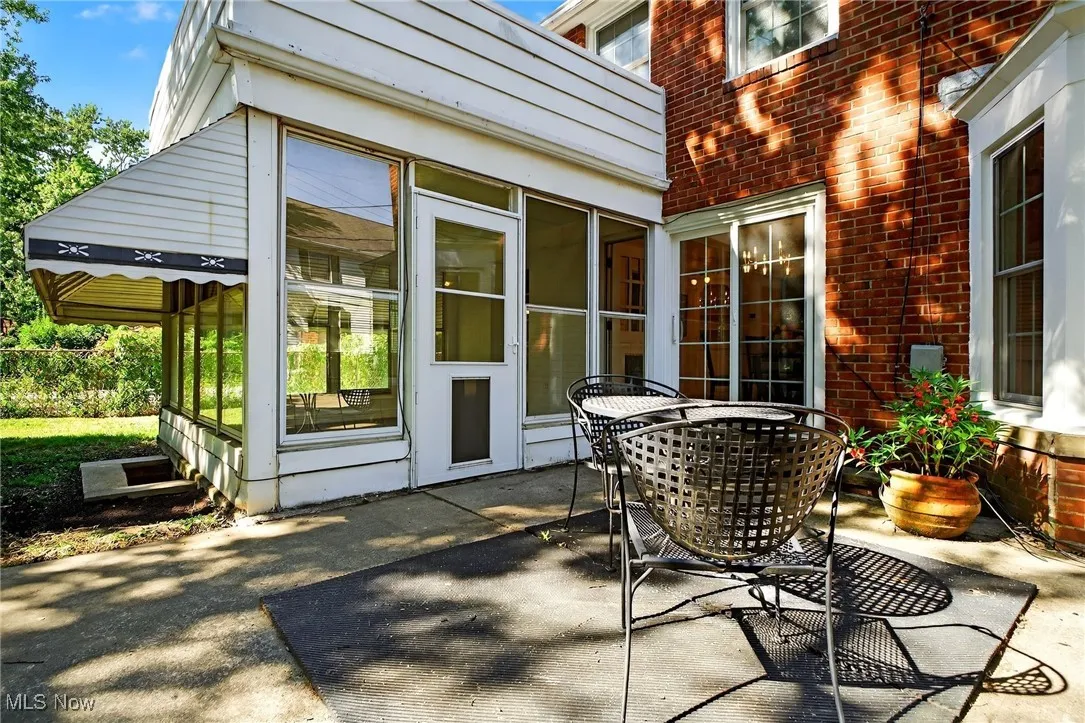 View of patio / terrace with a sunroom and outdoor dining space