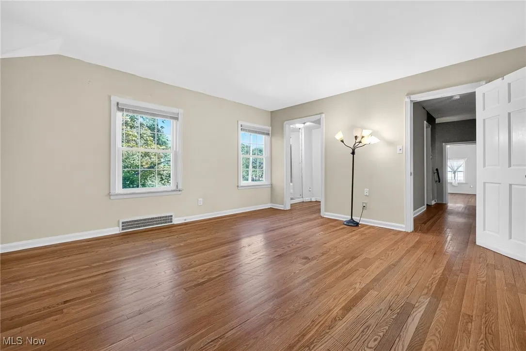 Unfurnished living room featuring plenty of natural light and wood finished floors