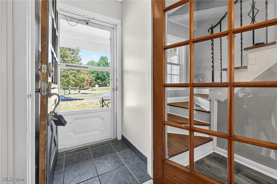 Doorway to outside with baseboards