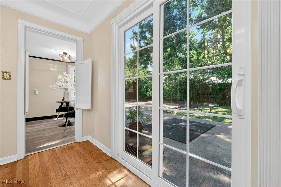 Entryway with wood finished floors and ornamental molding