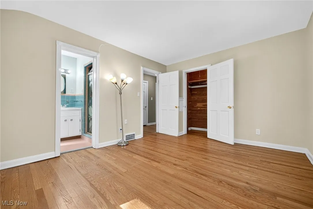 Unfurnished bedroom featuring light wood-type flooring and a closet