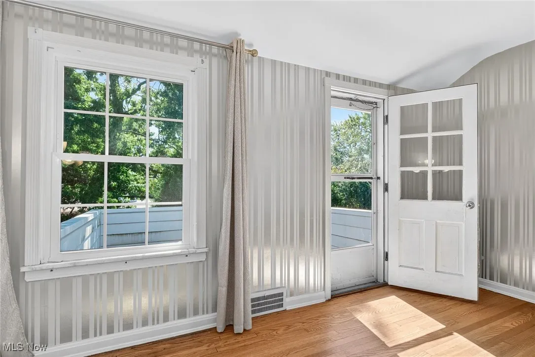 Doorway to outside featuring wood finished floors and baseboards
