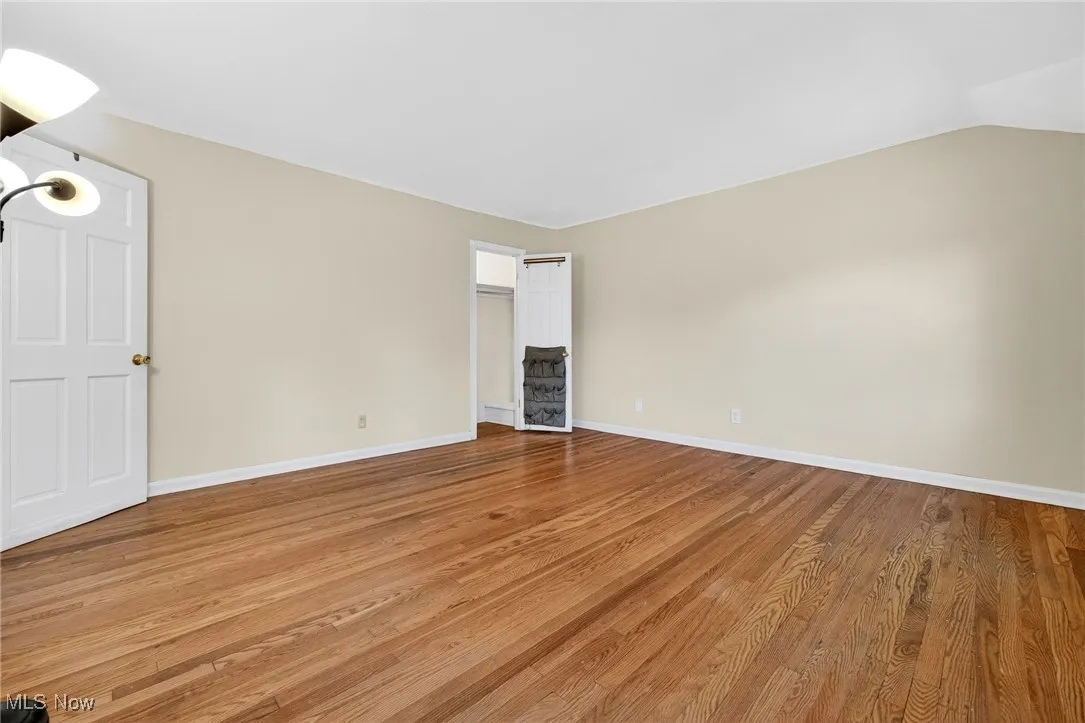 Unfurnished room featuring light wood-type flooring and baseboards