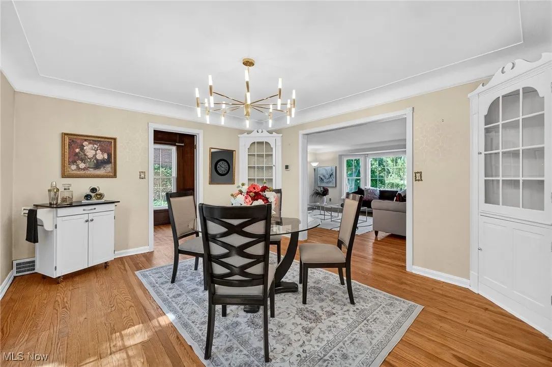 Dining space featuring light wood-style flooring and a chandelier