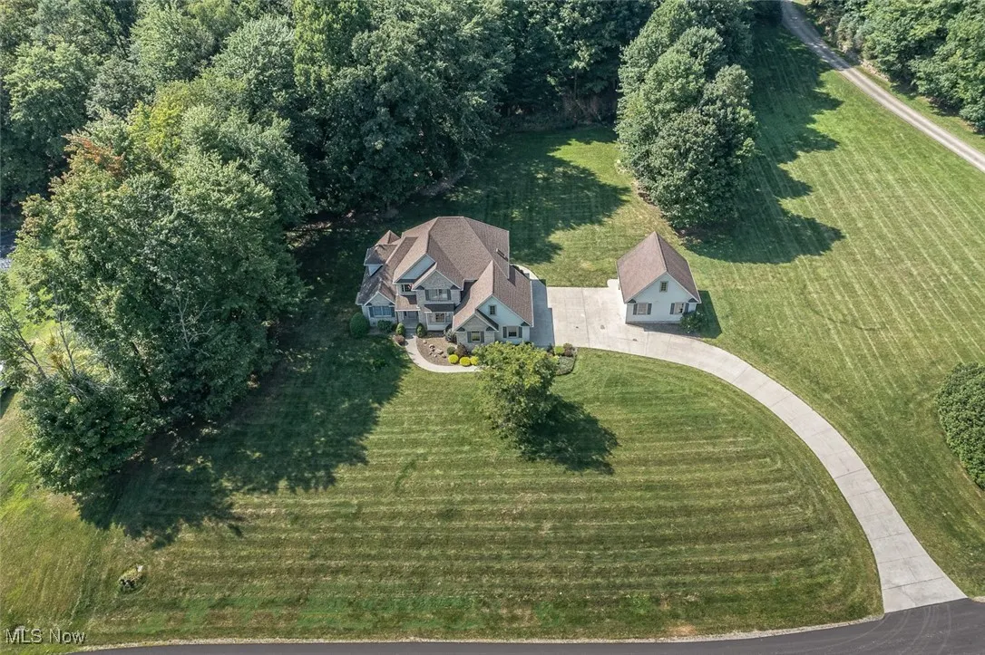 Nestled on over 3 private acres in a peaceful neighborhood within the desirable Copley School District