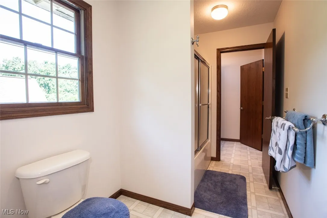 Upstairs guest bathroom door leads to separate vanity.