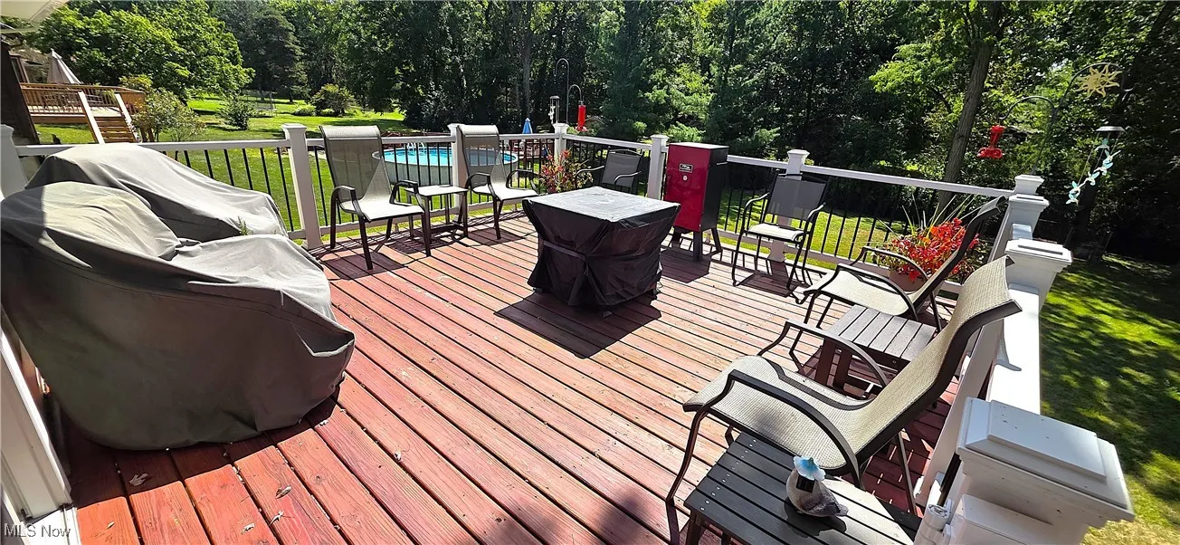 Raised deck overlooking the wooded backyard.