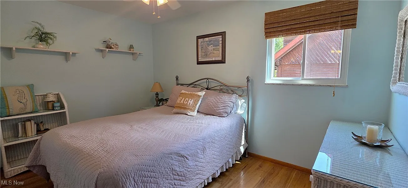 2nd floor Bedroom with wood finished floors and a ceiling fan