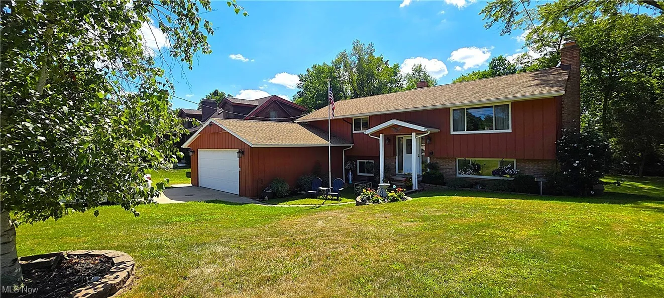 Raised ranch featuring an attached two car garage