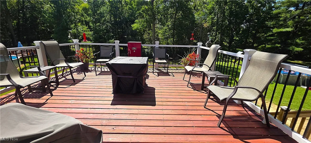 Raised deck overlooking the wooded backyard.