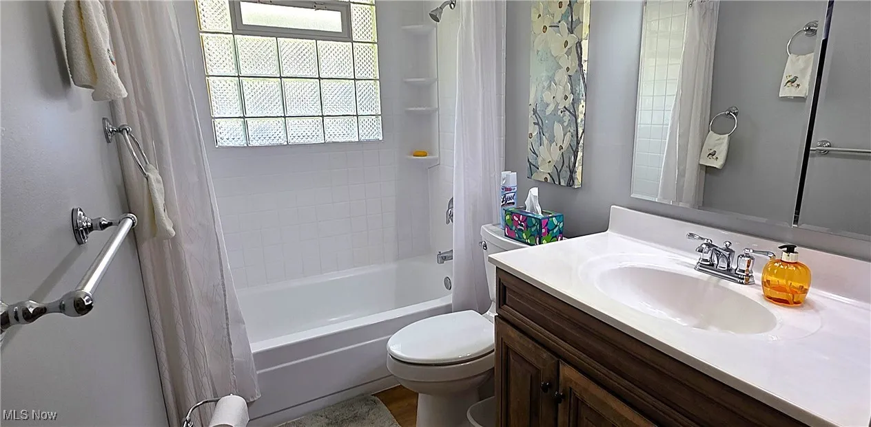 2nd floor Bathroom with shower / bathtub combination with curtain and vanity