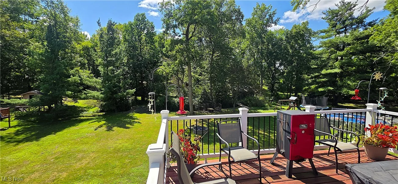 Raised deck overlooking the wooded backyard.