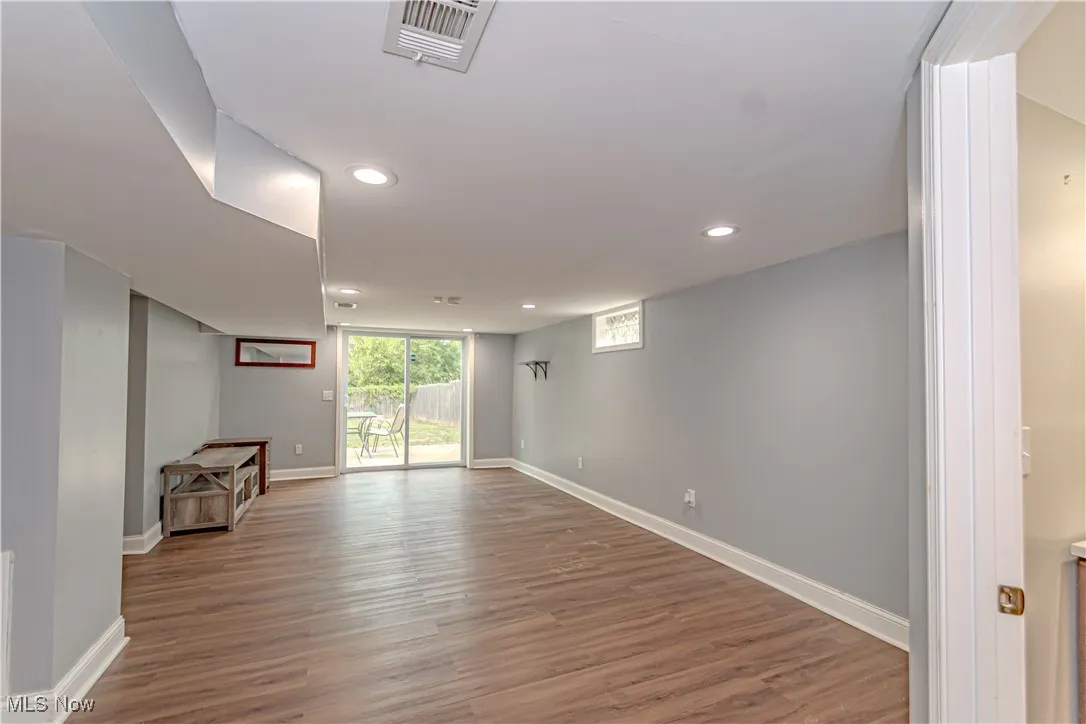 Basement featuring light wood-type flooring and recessed lighting