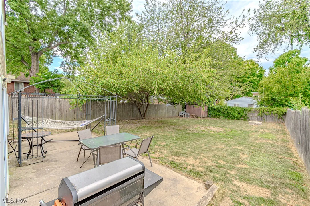 Fenced backyard featuring a patio area and outdoor dining area
