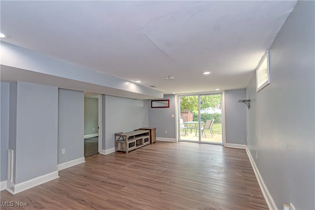 Unfurnished living room featuring wood finished floors and recessed lighting