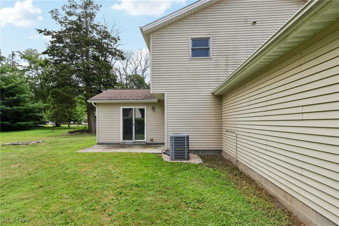 Rear view of property featuring a patio and a yard