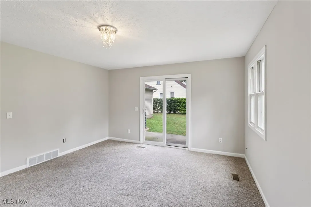 Carpeted spare room with baseboards and a textured ceiling