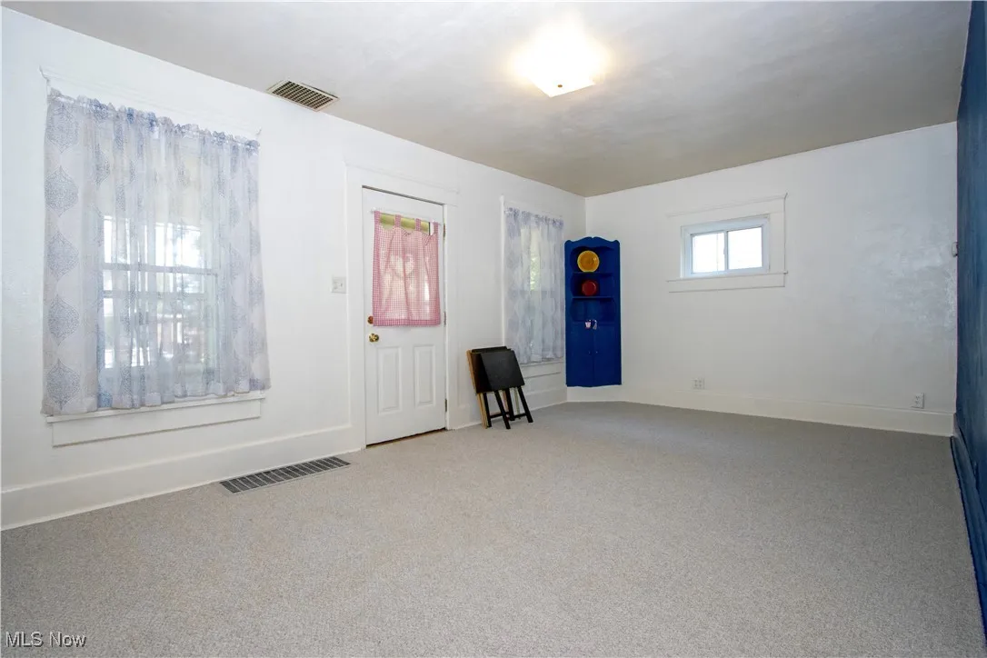 Entrance foyer featuring carpet floors and baseboards