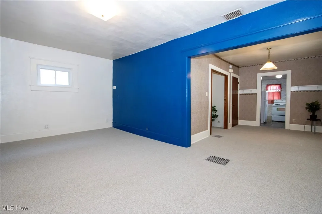 Empty room with carpet flooring and baseboards