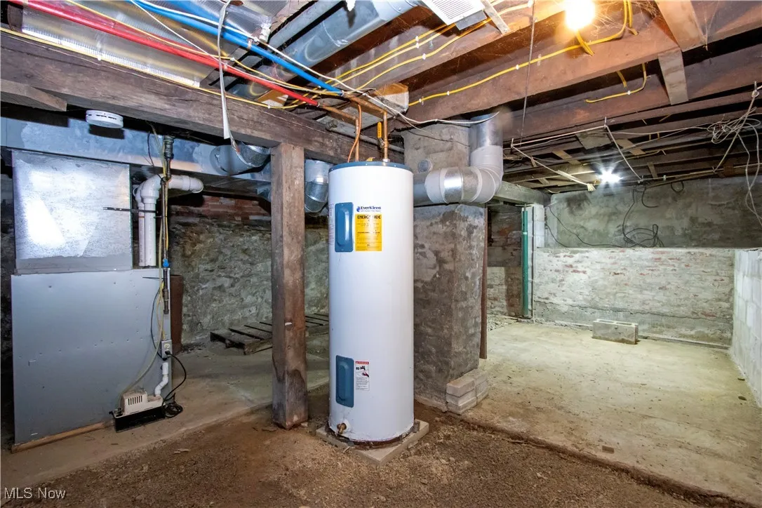 Unfinished basement with electric water heater and heating unit