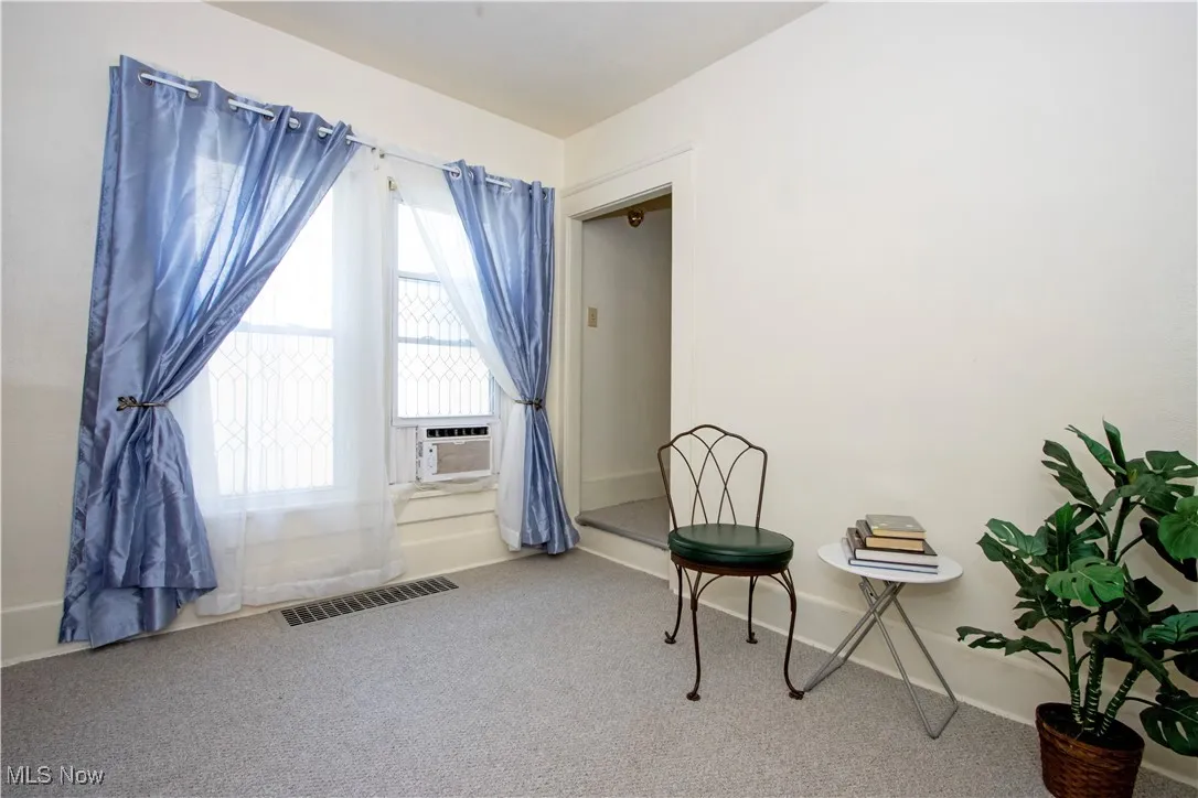 Sitting room with carpet flooring and baseboards