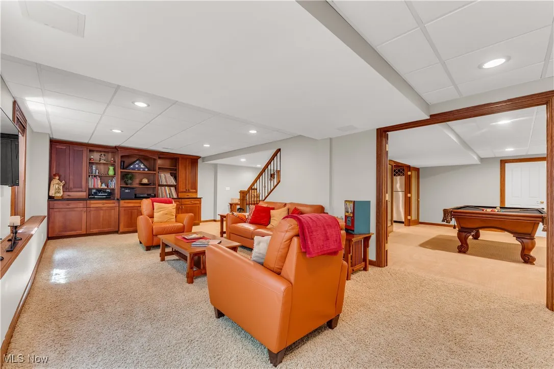 Family room has built in cabinets w/granite and French doors to the pool room or game room