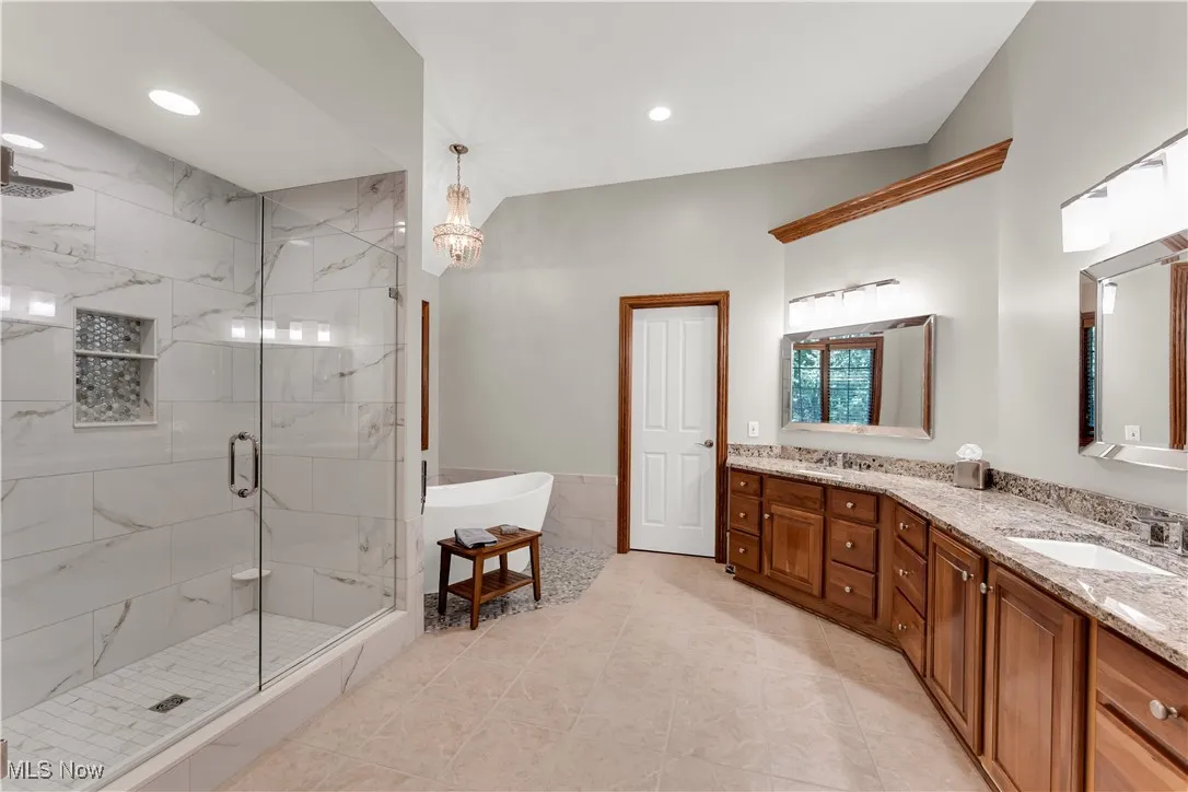 Gorgeous master bath w/his & hers walk in closets
