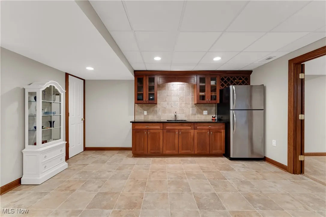 Lower level kitchen open to family room and French doors to pool room