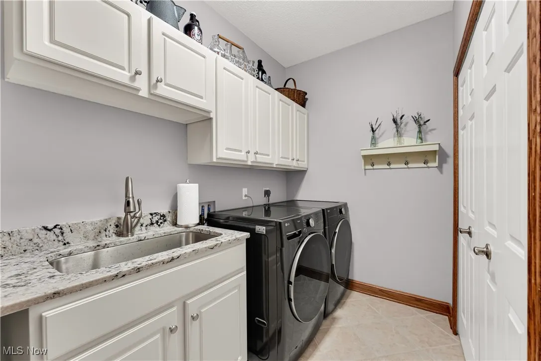 1st floor laundry with closet and cabinets w/granite