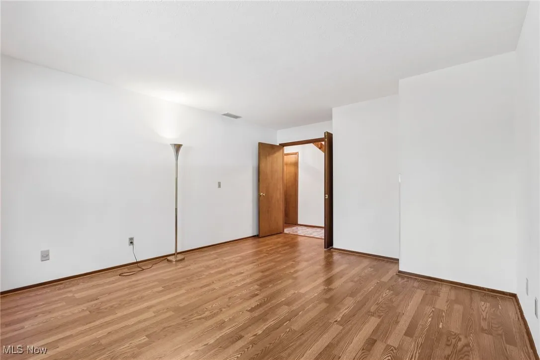 Empty room featuring light wood-style flooring and baseboards