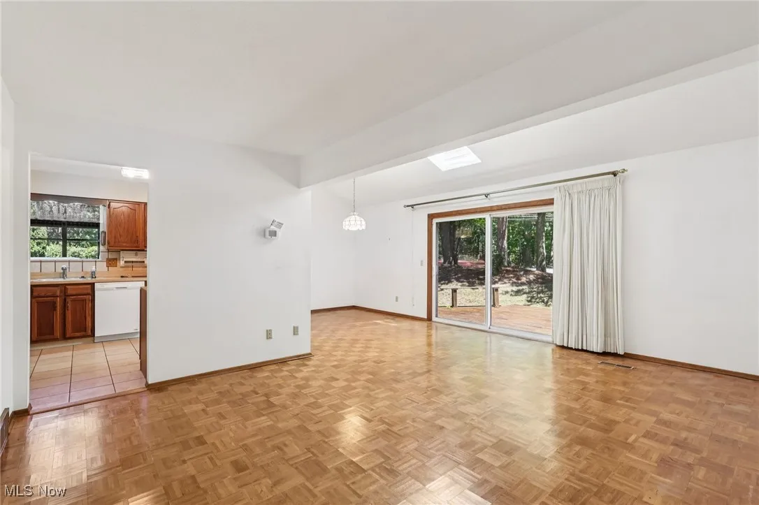 Spare room featuring baseboards and a sink
