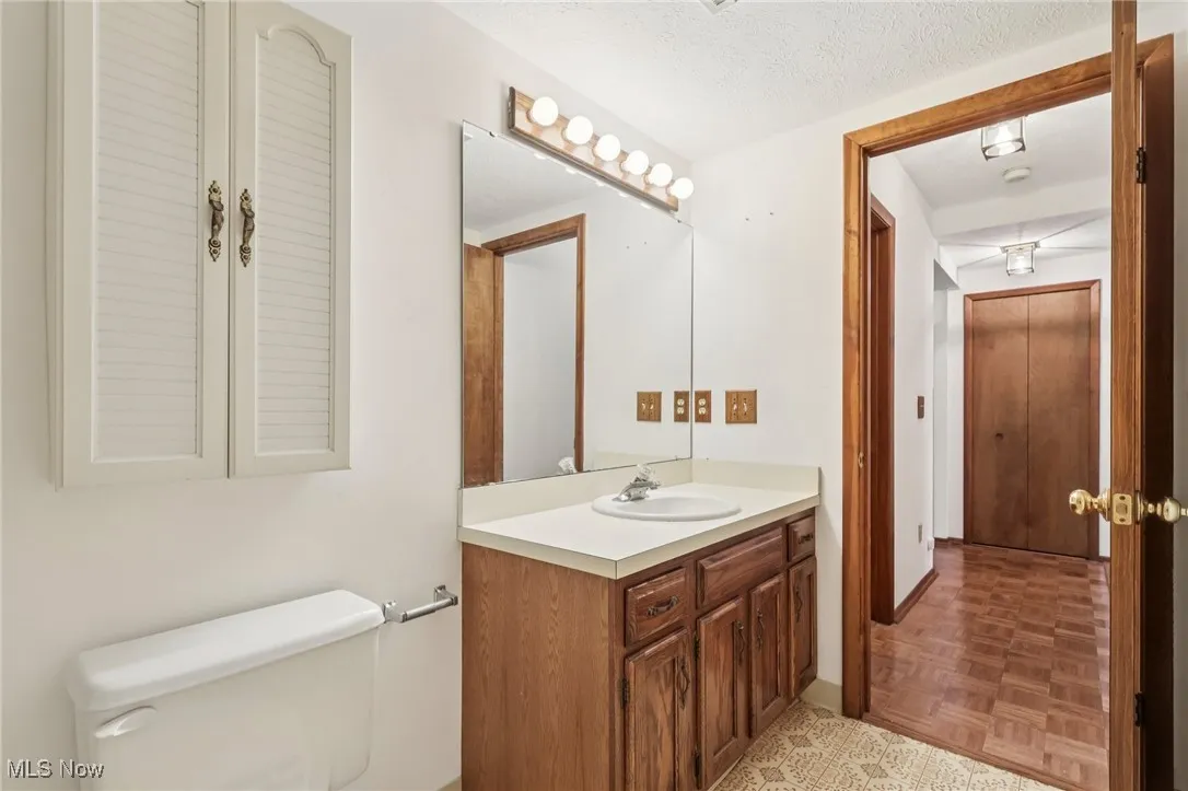 Bathroom featuring vanity and a textured ceiling