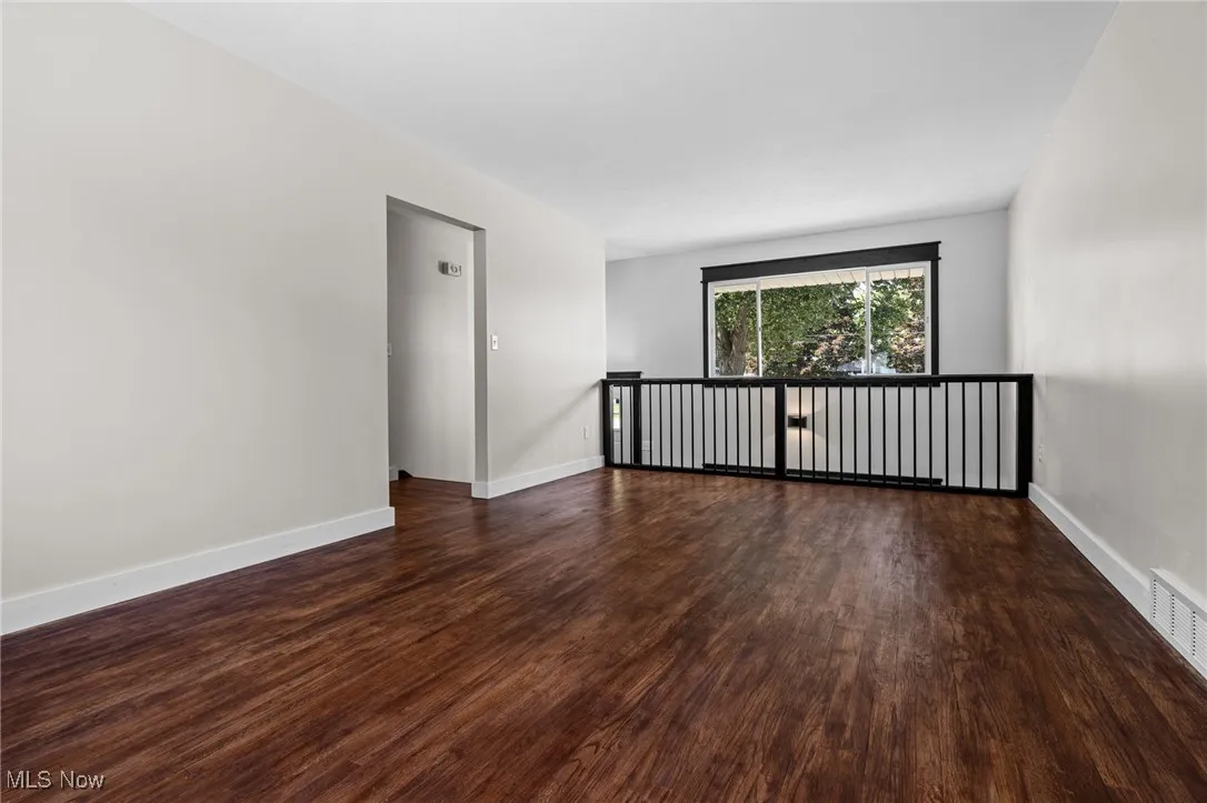 Living room with dark wood-style flooring and open feeling