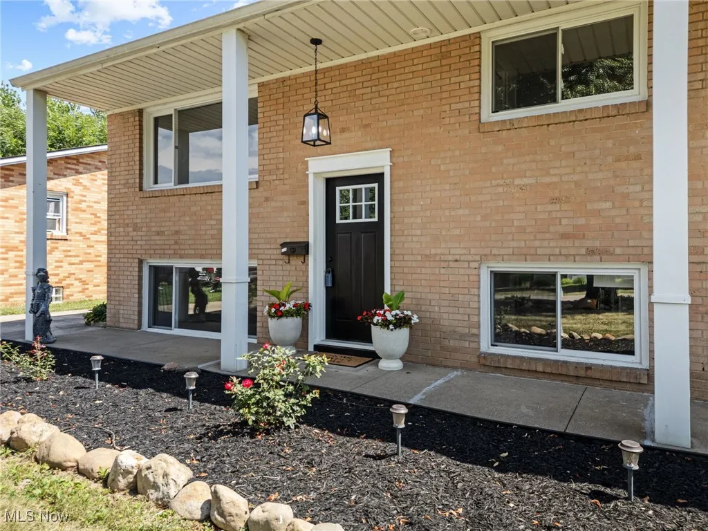 Property entrance with brick exterior and covered porch