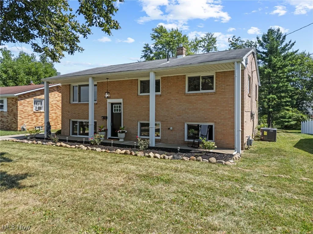 Bi-level home featuring a nicely landscaped front yard, brick exterior and new central air unit