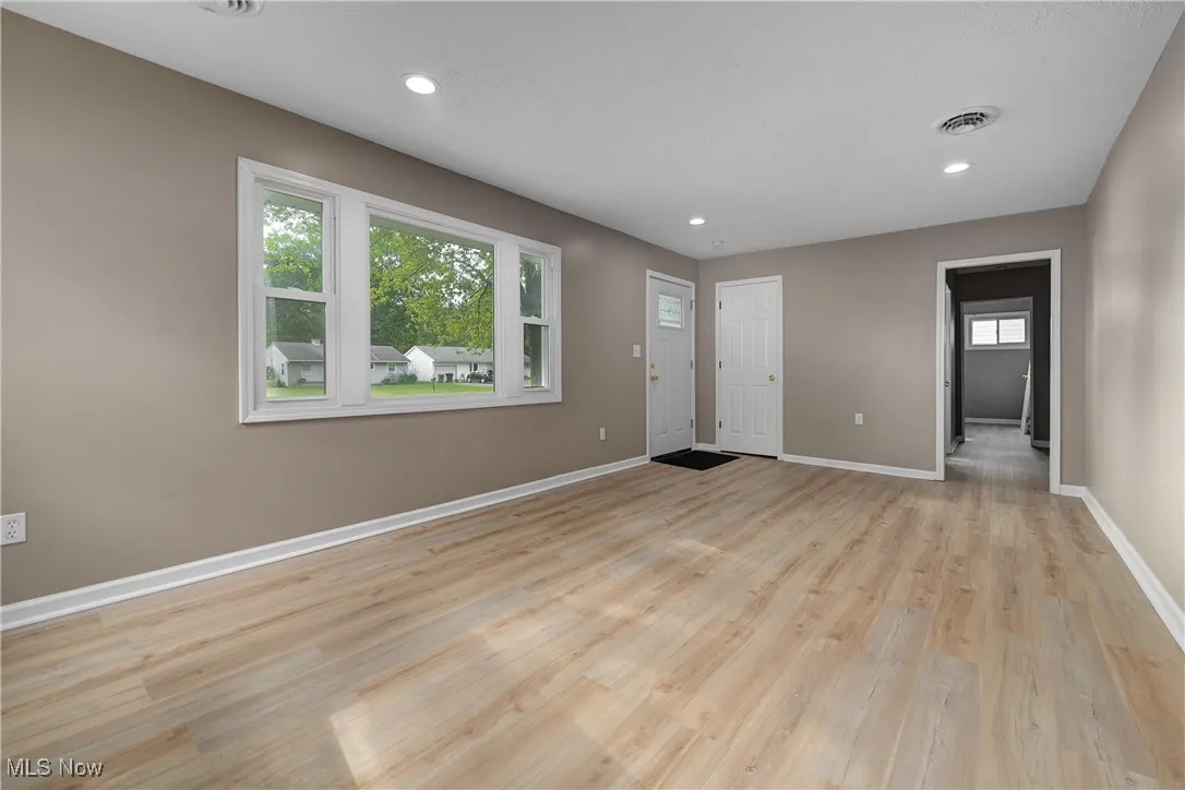 Unfurnished living room with recessed lighting and light wood-style flooring