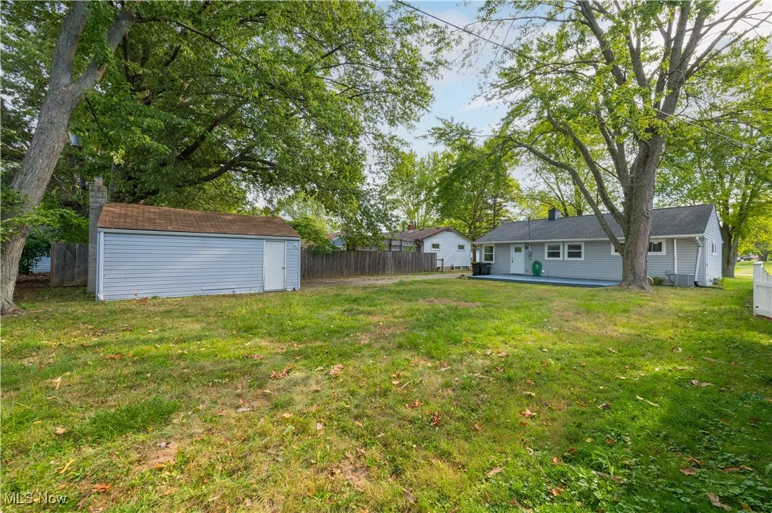View of yard featuring a storage shed and a patio