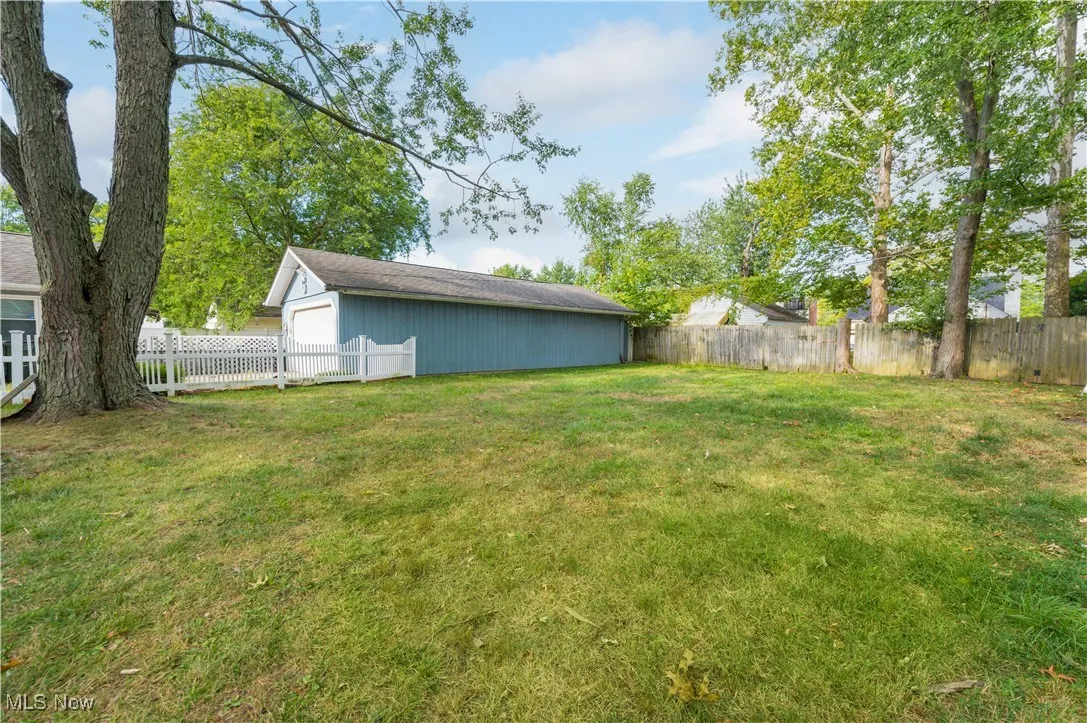 Fenced backyard with an outbuilding